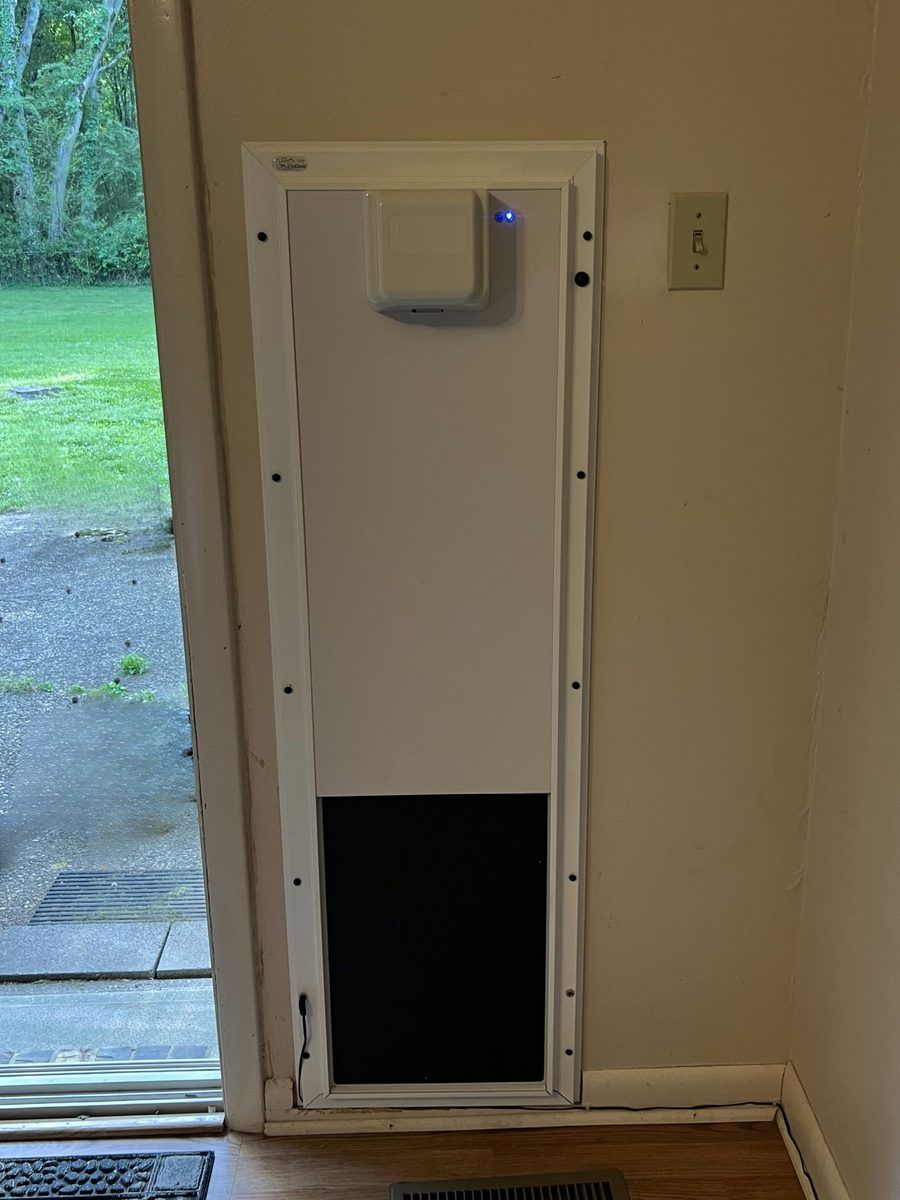 PlexiDor Electronic pet door installed in a door beside a sliding glass door, Birmingham area home